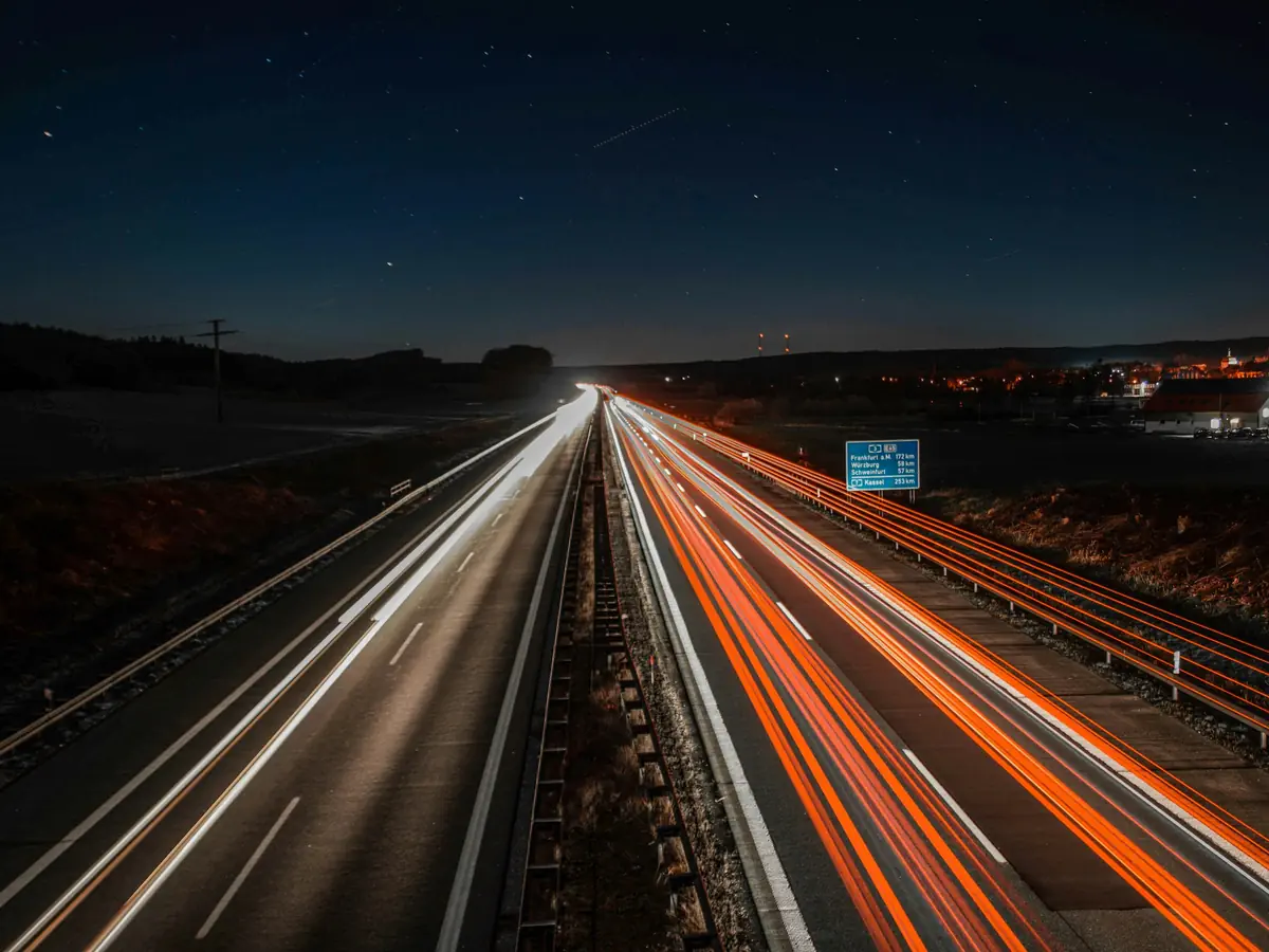 Motorway at night with light trails. Our regular routes: Austria, Slovenia, Croatia, Romania, Lithuania, Latvia and Finland.